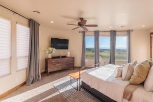 a bedroom with a bed and a large window at Chip Shot in St. George