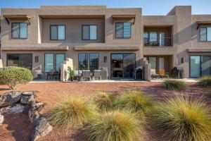 a house with large windows and grass at Hoodoo Haute in St. George