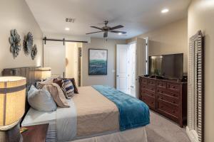 a bedroom with a bed and a flat screen tv at Hoodoo Haute in St. George +27 photos
