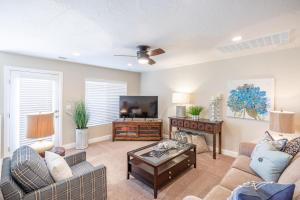 a living room with a couch and a tv at Hoodoo Haute in St. George