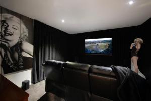 a living room with a couch and a television at Alofi in Hepburn Springs