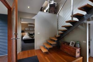 a staircase in a house with a bedroom at Alofi in Hepburn Springs