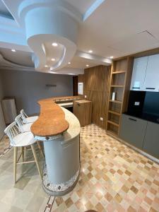 a kitchen with a counter and a table and chairs at Crescent of the Lake Luxury Apartment in Tunis