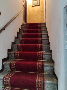 a set of stairs with red carpet at Casa del Centro 2P in Santa Caterina Villarmosa