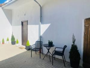 a patio with two chairs and a table and a door at Cozy Studio in Sibiu