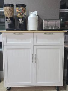 a white cabinet with a counter top on top at Value Lodge in Alpine