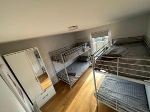 a room with two bunk beds and a mirror at North Wales Lake View 2 Bedroom in Caernarfon +20 photos