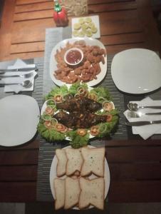 a table with plates of food on a table at Villa Riverside in Aluthgama
