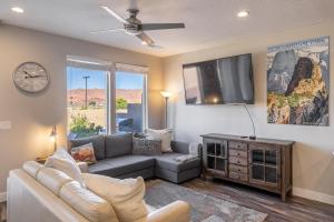 a living room with a couch and a flat screen tv at Sunny 3-Bedroom Villa in St. George
