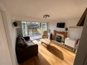 a living room with a couch and a fireplace at North Wales Lake View 2 Bedroom in Caernarfon