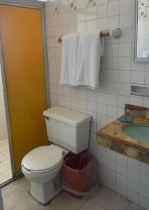 a bathroom with a toilet and a sink at Hotel Santa Barbara in Mazatlán