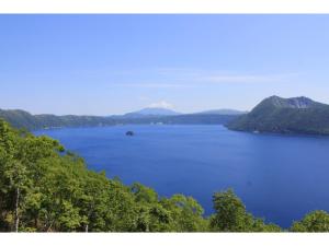 a view of a large body of water with trees at Mashuko Youth Hostel - Vacation STAY 00253v in Teshikaga