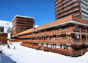 a large building in the snow next to a ski slope at LE VERCORS - Appartement VERCORS 111 pour 4 Personnes 98 in Plagne Villages