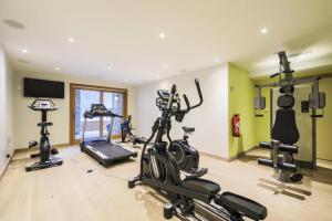 a gym with several exercise bikes and a television at Résidence Premium L'Hévana - maeva Home - Appartement Duplex 3 pièces 8 pe 10 in Les Allues