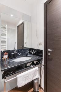 a bathroom with a sink and a mirror at Riverside Palace Suites in Prague