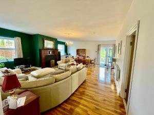 a living room with a large couch in a room at Spacious Garden Flat in Snowdonia National Park in Brynkir