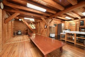 a large wooden room with a wooden bench in a room at Logland Okumino - Camp - Vacation STAY 42149v in Gujo