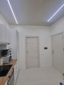 a kitchen with white walls and a sliding door at Appartamento Crihana in Aosta