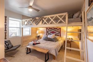 a bedroom with two bunk beds and a couch at Taking Flight in Ivins +44 photos