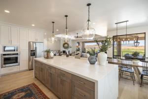 a kitchen with a large island in a kitchen with a living room at Taking Flight in Ivins