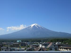 a view of a snow covered mountain with a city at Fujisan Resort Hotel - Vacation STAY 57971v in Fujikawaguchiko