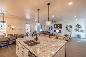 a kitchen and living room with a sink and a couch at Casa Ledges in Ivins