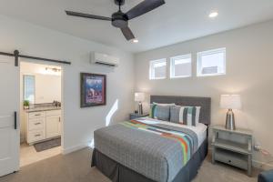 a bedroom with a bed and a ceiling fan at Casa Ledges in Ivins +35 photos