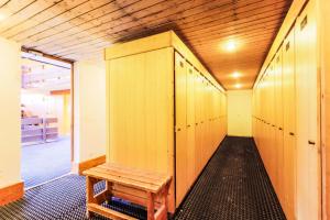a locker room with a wooden bench in it at Résidence Les Brigues - maeva Home - Appartement 2 Pièces 6 Personnes – C 02 in Courchevel