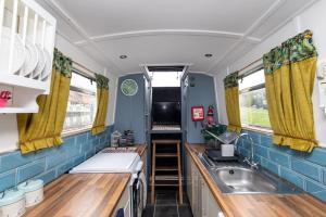 a small kitchen with a sink and a stove at Lazy Days Narrow Boat in Stanley