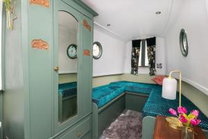 a room with two blue beds in a room at Lazy Days Narrow Boat in Stanley