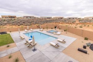 IvinsにあるSand Cove Villa at The Ledges with Private Poolの椅子とパラソル付きのスイミングプールのイメージ