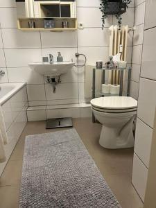 a bathroom with a toilet and a sink at Sarah's Nest in Kerpen
