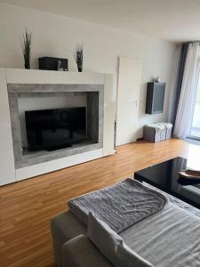 a living room with a fireplace and a couch at Sarah's Nest in Kerpen