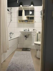a white bathroom with a sink and a toilet at Sarah's Nest in Kerpen