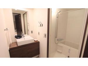 a bathroom with a sink and a shower and a mirror at River Side Arashiyama - Vacation STAY 86216v in Kyoto +45 photos
