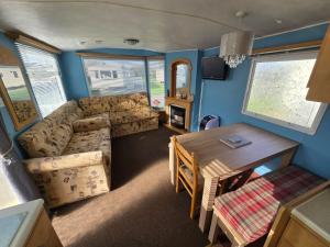 a living room with a table and a dining room at The daxie 3-Bed caravan in Butlins Skegness in Skegness