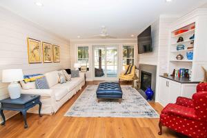 a living room with a white couch and a fireplace at Soundside, Private Pool, Den, Yard, Screened Porch, SH106, Turners Tide in Duck