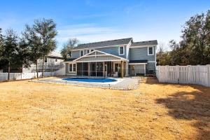 a house with a pool in a yard at Soundside, Private Pool, Den, Yard, Screened Porch, SH106, Turners Tide in Duck