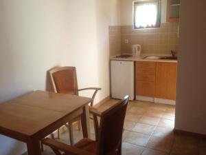 a kitchen with a table and chairs and a sink at Autocamp Skalice in Slapy