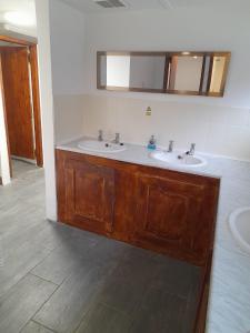 a bathroom with two sinks and a mirror at Rooms & Camping Pods at Colliford Tavern in Bodmin
