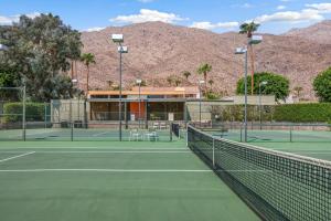 a tennis court with mountains in the background at Eclectic & Comfortable Canyon Corridor - A Ryson Property in Palm Springs