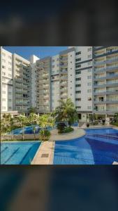 a large apartment complex with a swimming pool and buildings at Veredas do Rio Quente in Rio Quente