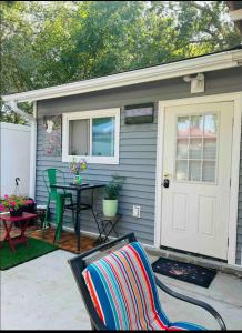 a house with a patio with a table and a door at Fancy studio private entrance in Selden