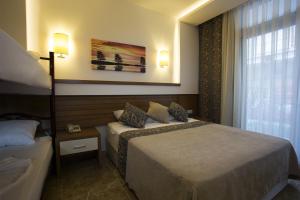 a hotel room with two beds and a window at Sun Club Side Hotel - All inclusive in Side +34 photos