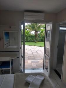 a bedroom with a door open to a patio at Rota do Sol Praia Hotel in Guaratuba
