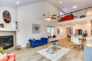 a living room with a blue couch and a fireplace at Spacious Royse City Home with Community Pool Access in Royse City