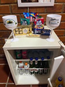 a refrigerator filled with food and snacks and drinks at Pousada Dona Felicidade Suítes in Tamandaré