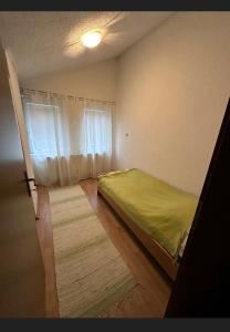 a bedroom with a bed and a window at A&F apartment in Pristina