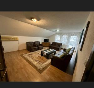 a living room with two couches and a table at A&F apartment in Pristina