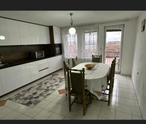 a kitchen with a table and chairs in a room at A&F apartment in Pristina +4 photos